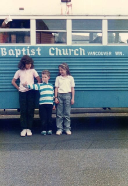 Posing in front of the buses used for the New Heights bus ministry.